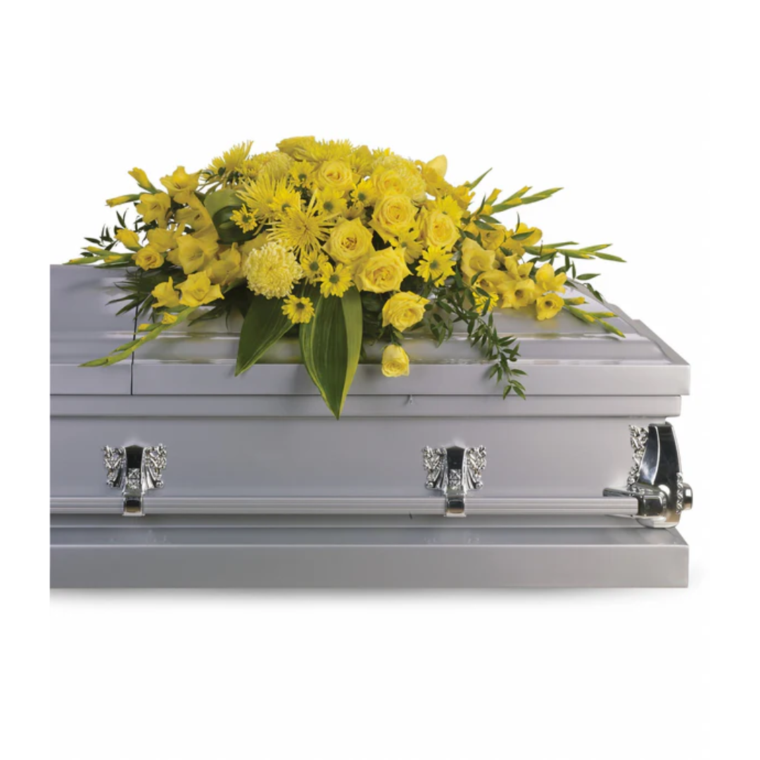 Silver casket with yellow floral arrangement
