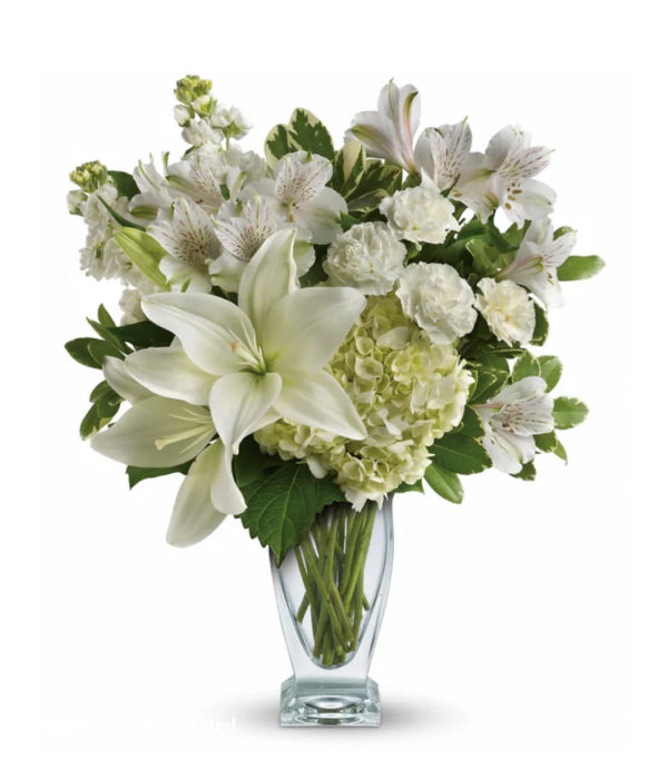 Purest love floral arrangement of white lilies and other flowers.