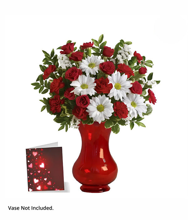 Red roses & daisies in a red vase.