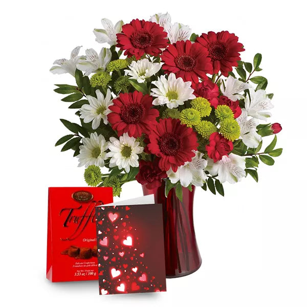 Valentine's Day bouquet with red gerbera daisies, card, and chocolates
